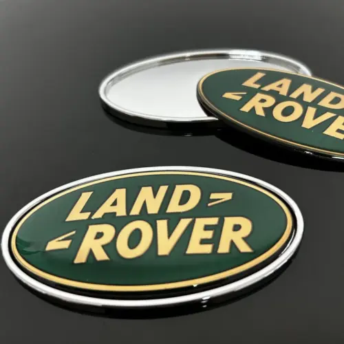 1x neu LAND ROVER Emblem + Trägerplatte 9 x 4,9cm grün/gold Emblem Schriftzug Logo Heck Grill LR053190 DAH100680 LR088950